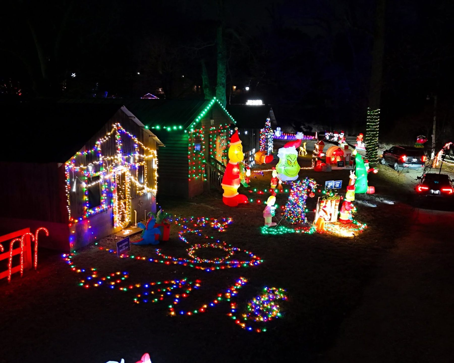 Grinch themed sponsored cabin Christmas light display at Lawrenceville Lights