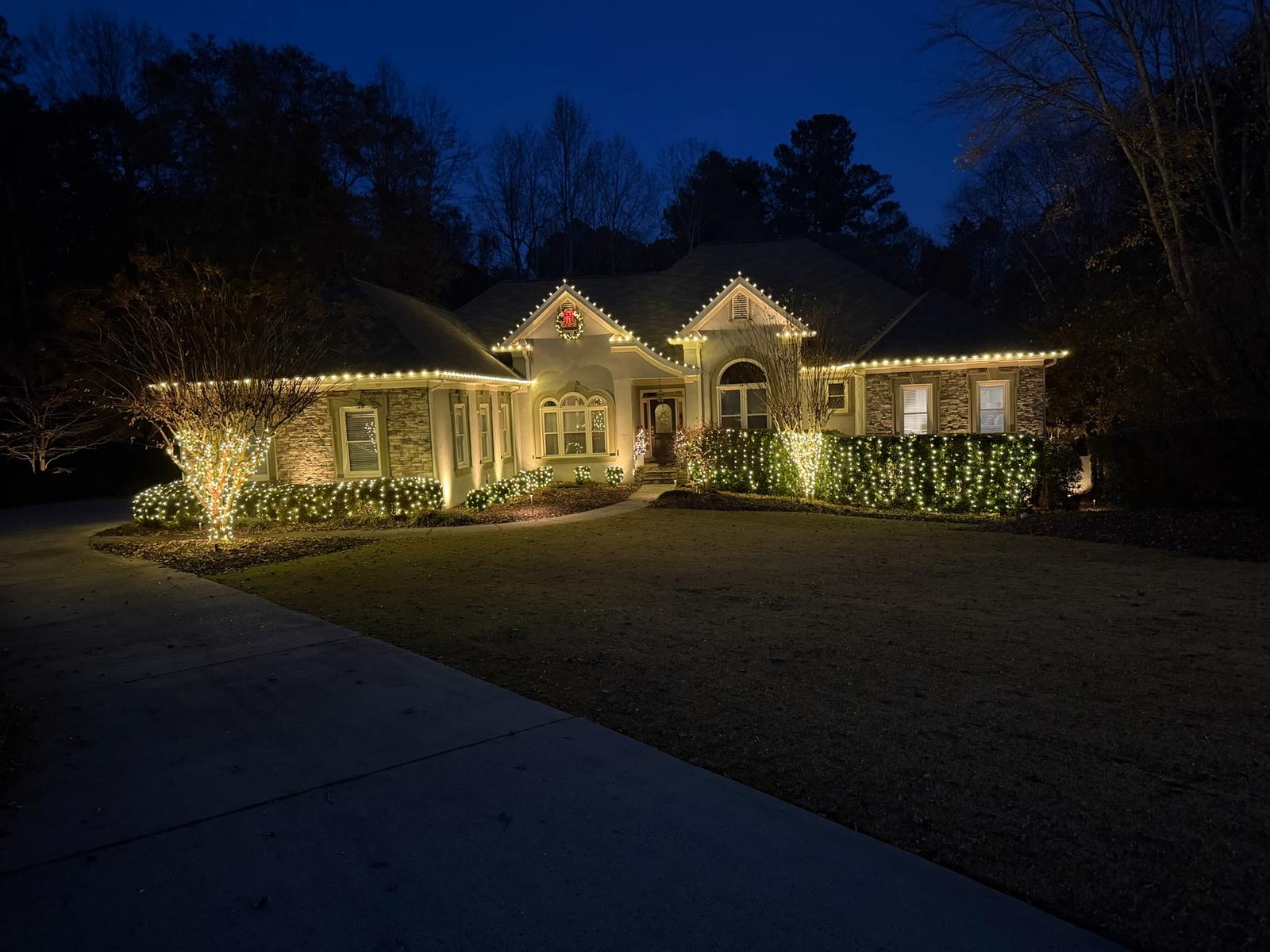 Landscape and bush Christmas light installation in Milton GA with wrapped trees