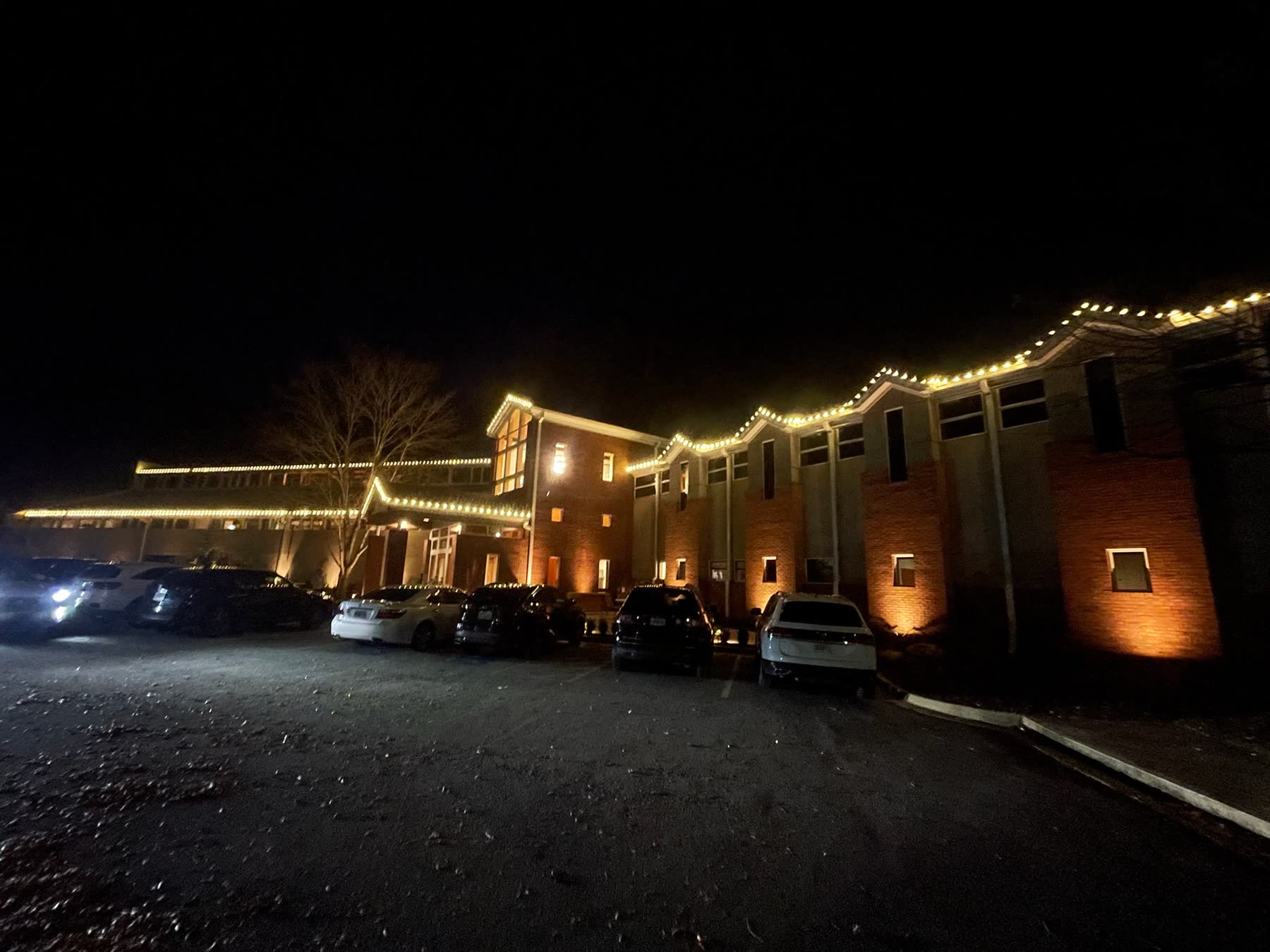 Atlanta church Christmas light installation with warm white steeple lighting