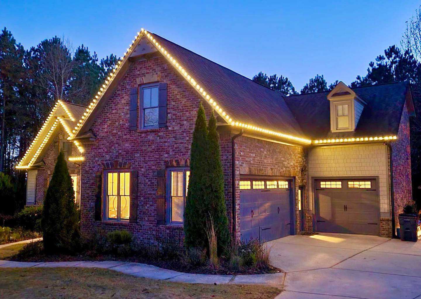 Brick home warm white Christmas lights in Roswell GA with full roofline C9 bulbs