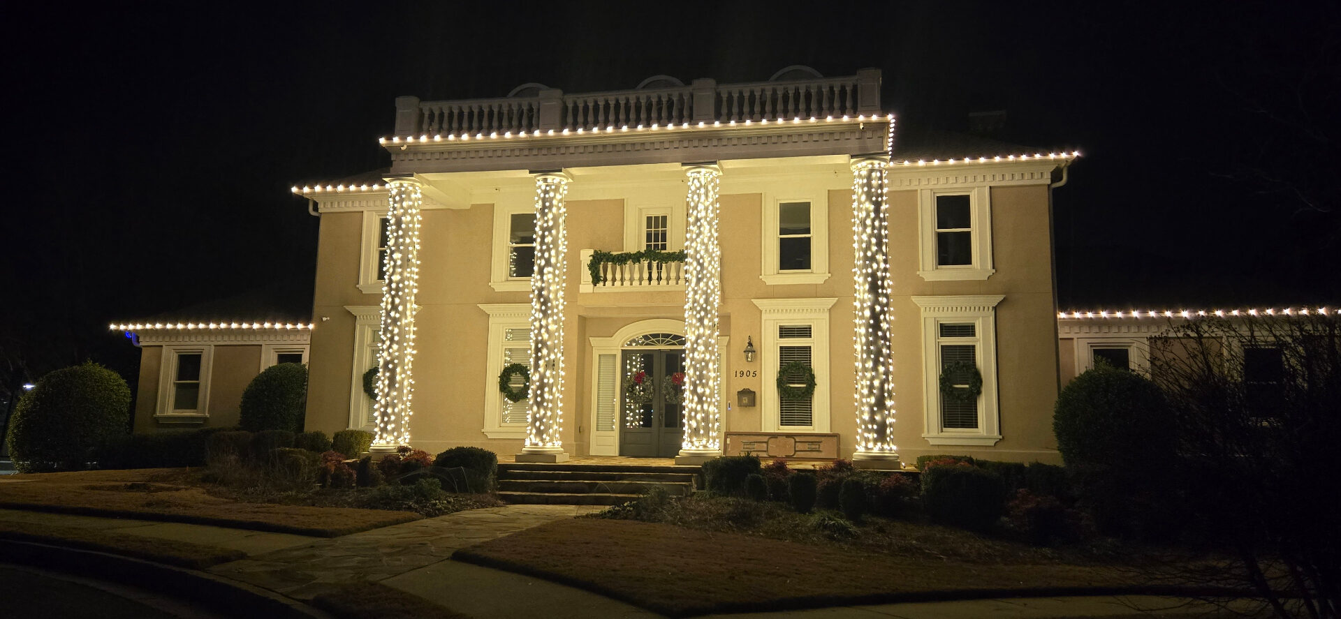 HOA clubhouse with column wrap and roofline warm white Christmas lights