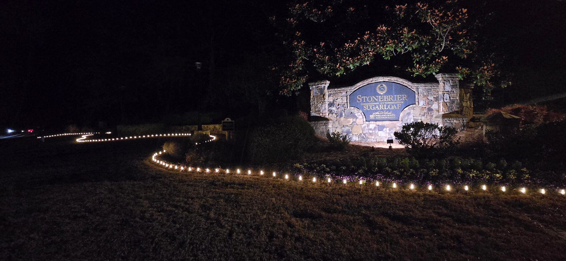 Sugarloaf HOA entrance with C9 pathway Christmas lights lining the drive