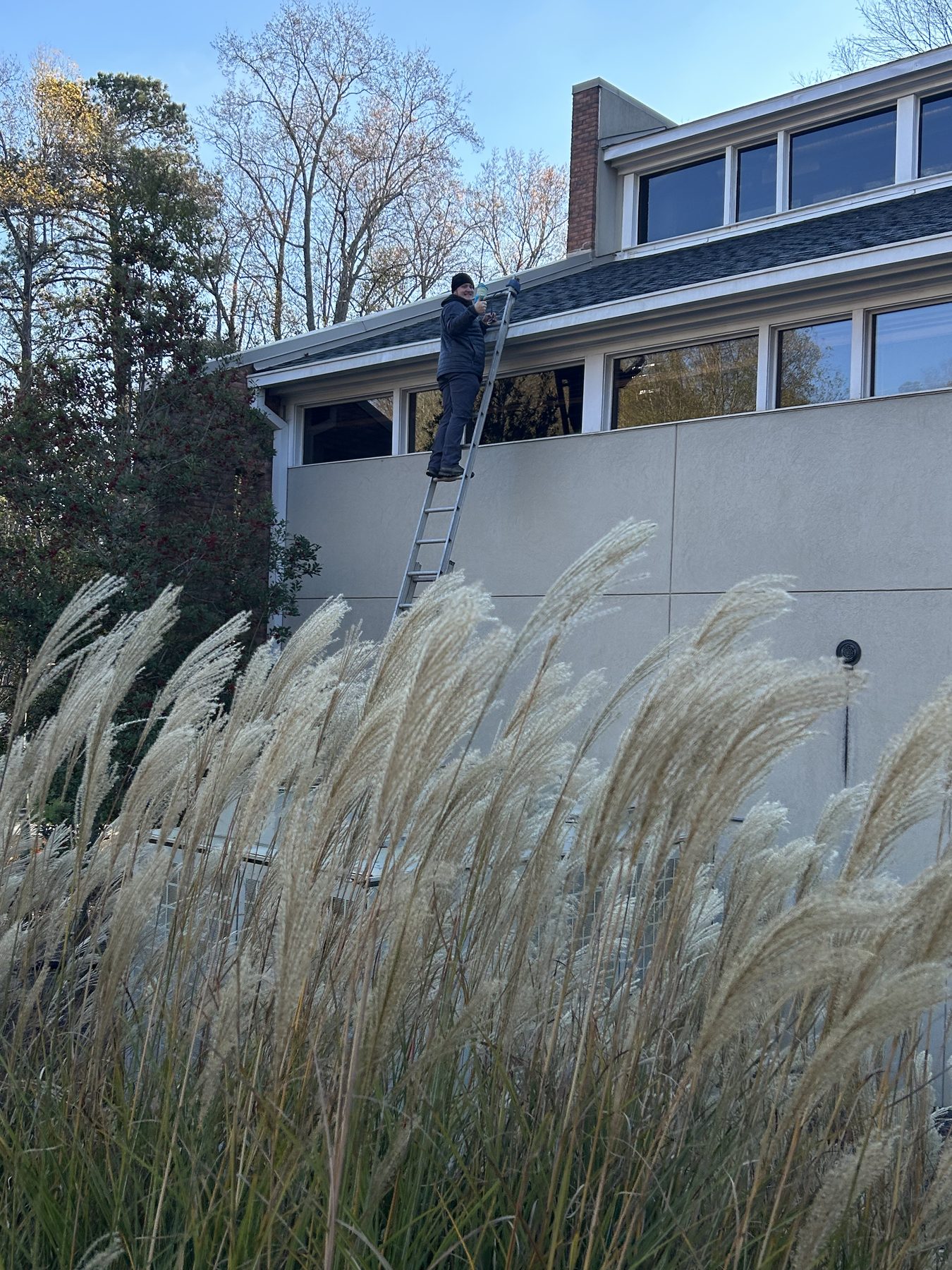 Professional Christmas light hanging team installing lights on an Atlanta home
