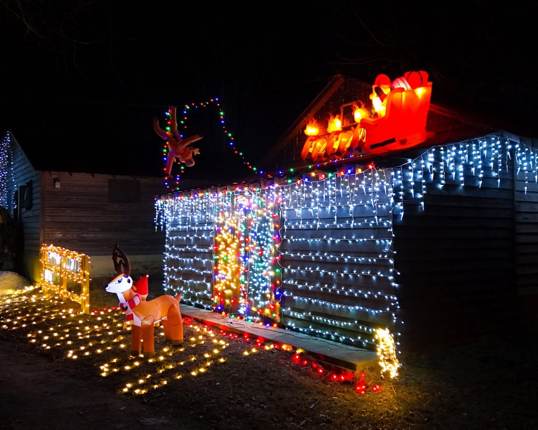 Santa sleigh and icicle lit cabin at Lawrenceville Lights community fundraiser