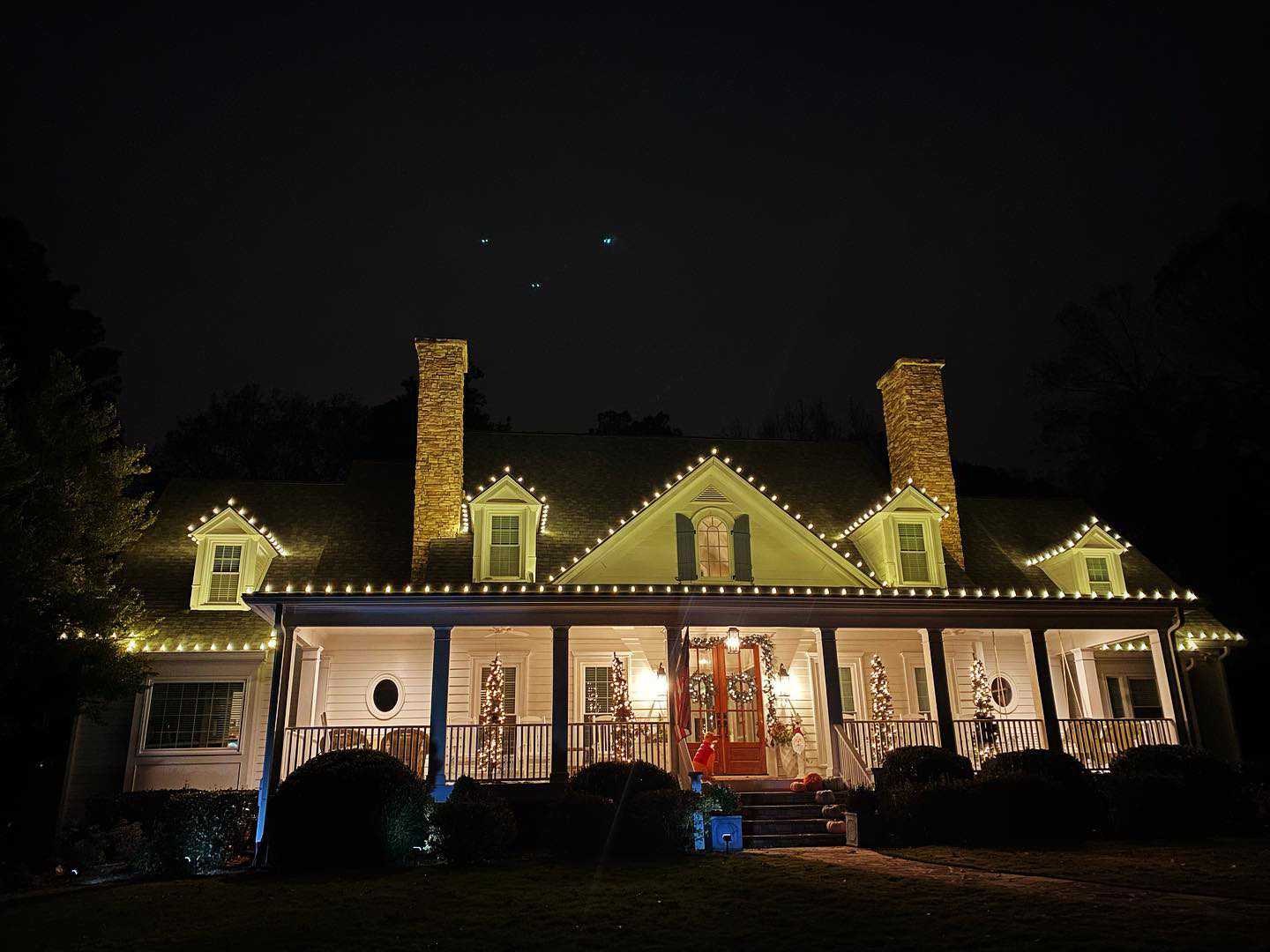 Porch column Christmas lights on Southern Atlanta home with lit garland