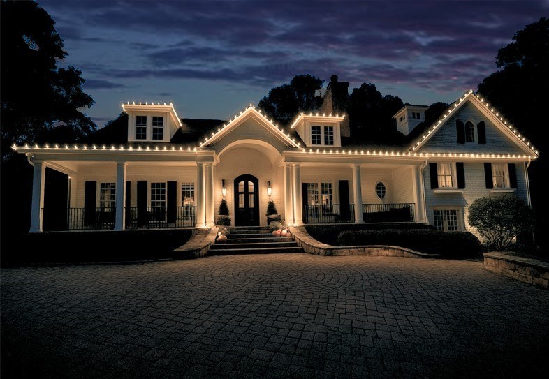 Top rated Christmas light installation on white Atlanta home at twilight
