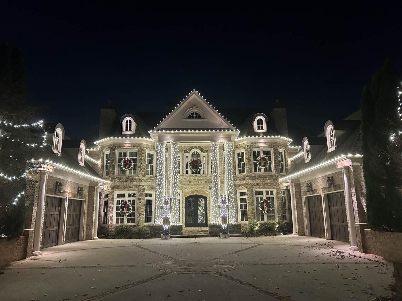 Professional Christmas light hanging service on stone mansion in Atlanta