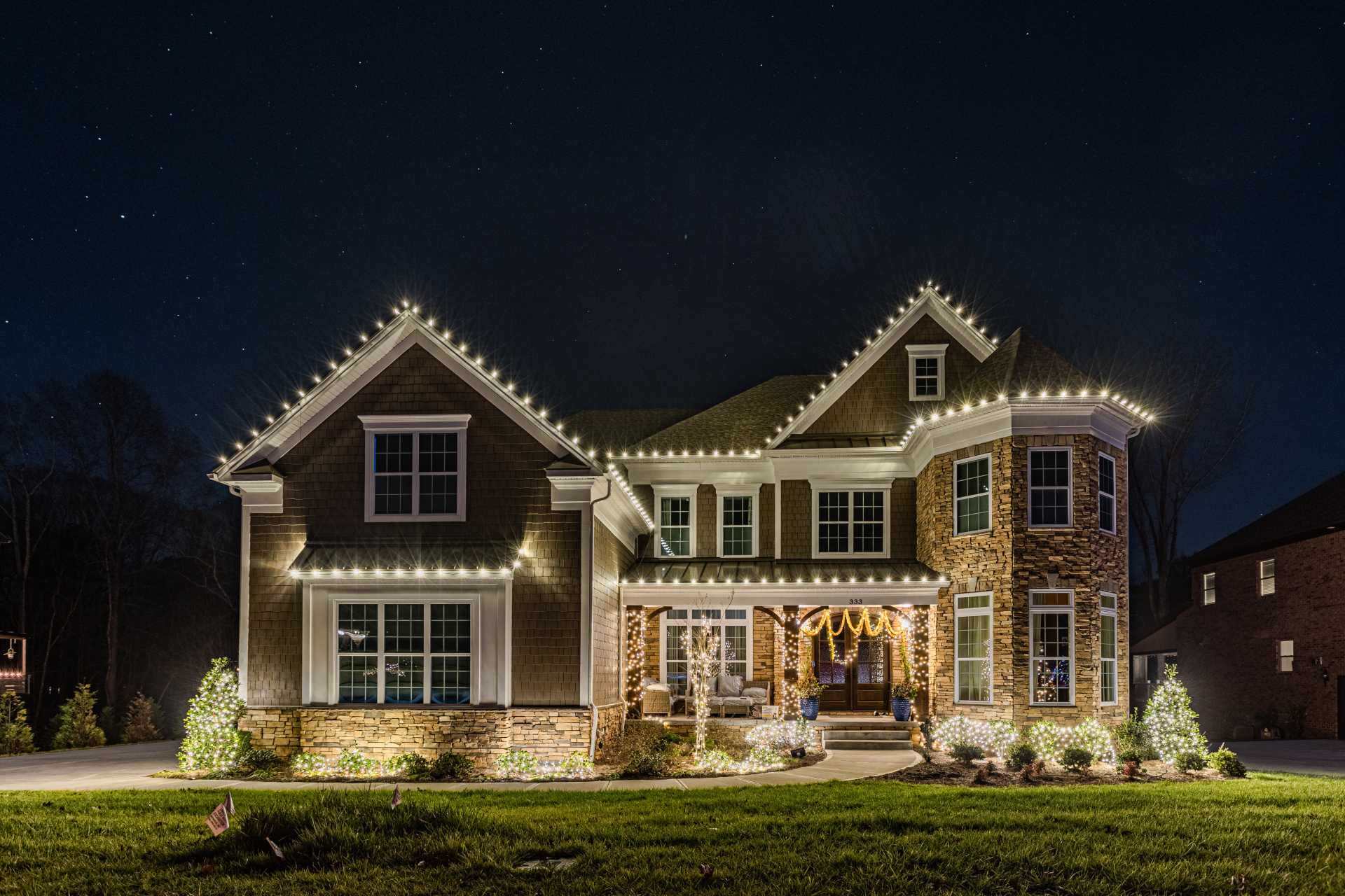 Tree wrapping with warm white Christmas lights Atlanta